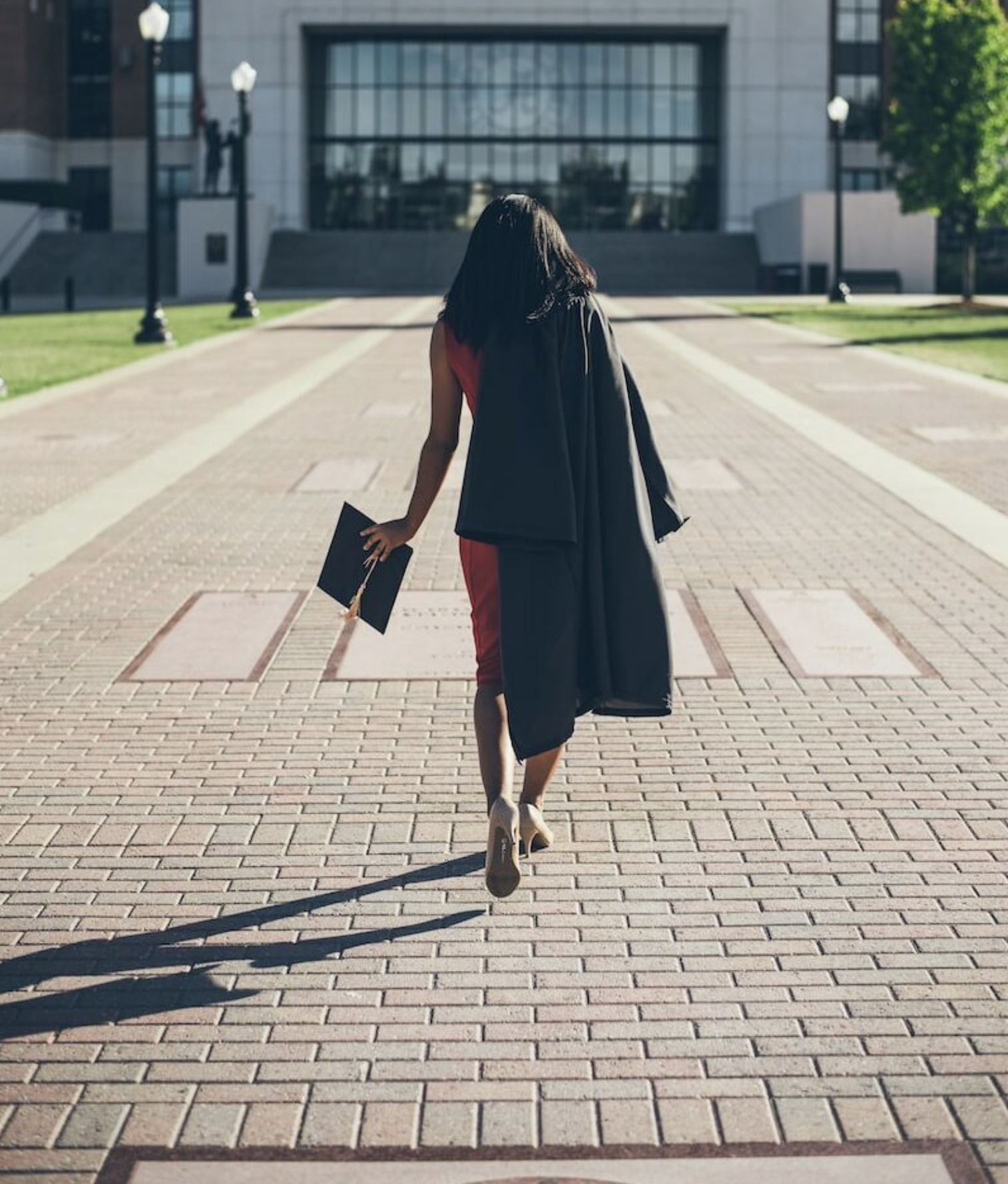 woman standing at facade of Alabama University building